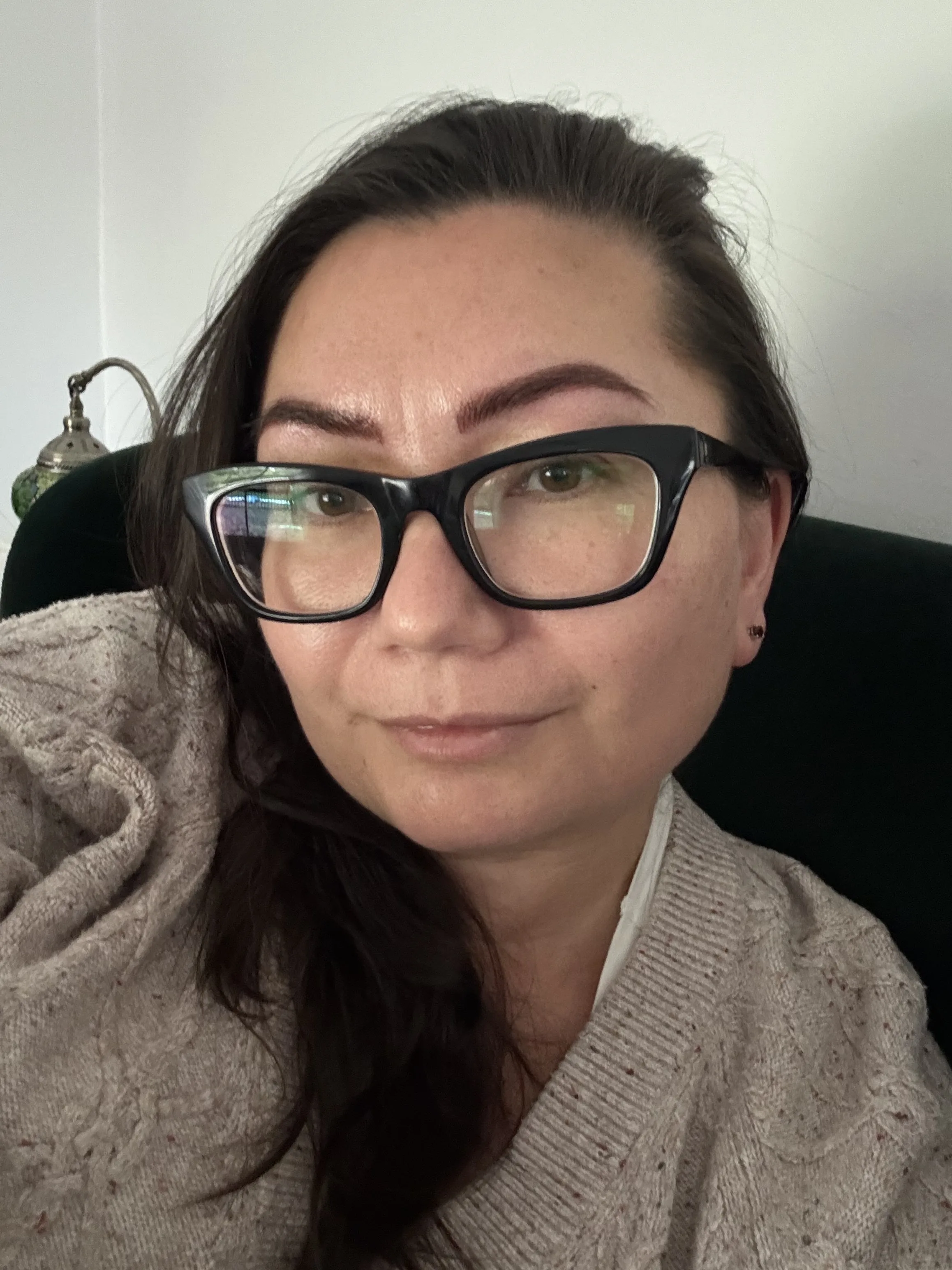 Healed natural brow result — client in glasses, high-resolution